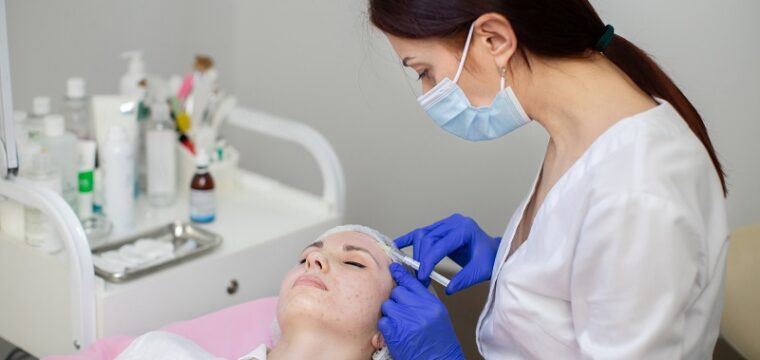 Aesthetic cosmetology in a beauty salon. Female cosmetologist makes rejuvenating botox anti wrinkle injections on the face of a beautiful woman. Skin revitalization, hydration.