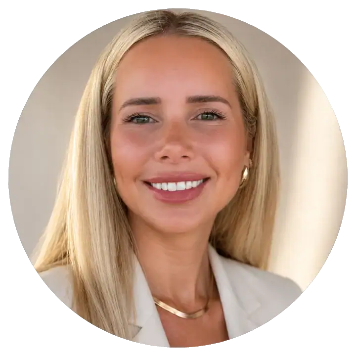 Smiling woman with blonde hair in professional attire at My Cosmetic Clinic.