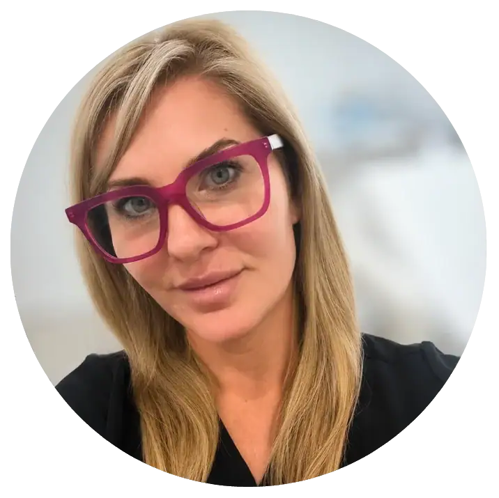 Professional woman with blonde hair and pink glasses at My Cosmetic Clinic.