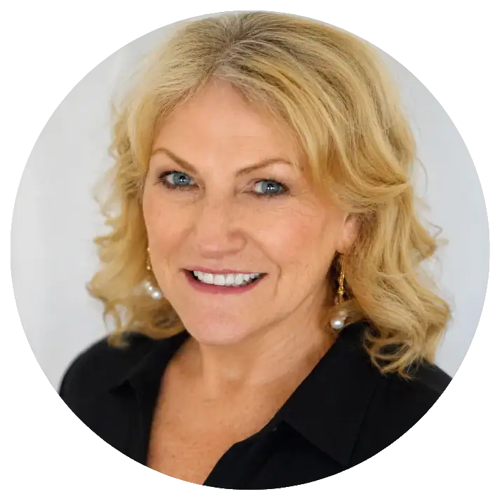 Professional woman with blonde hair and blue eyes smiling at My Cosmetic Clinic.