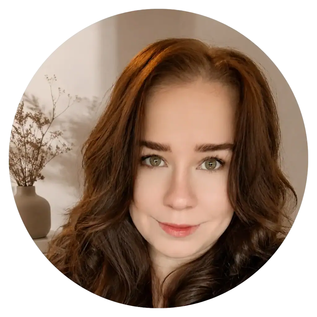 Portrait of a woman with wavy brown hair and green eyes at My Cosmetic Clinic.